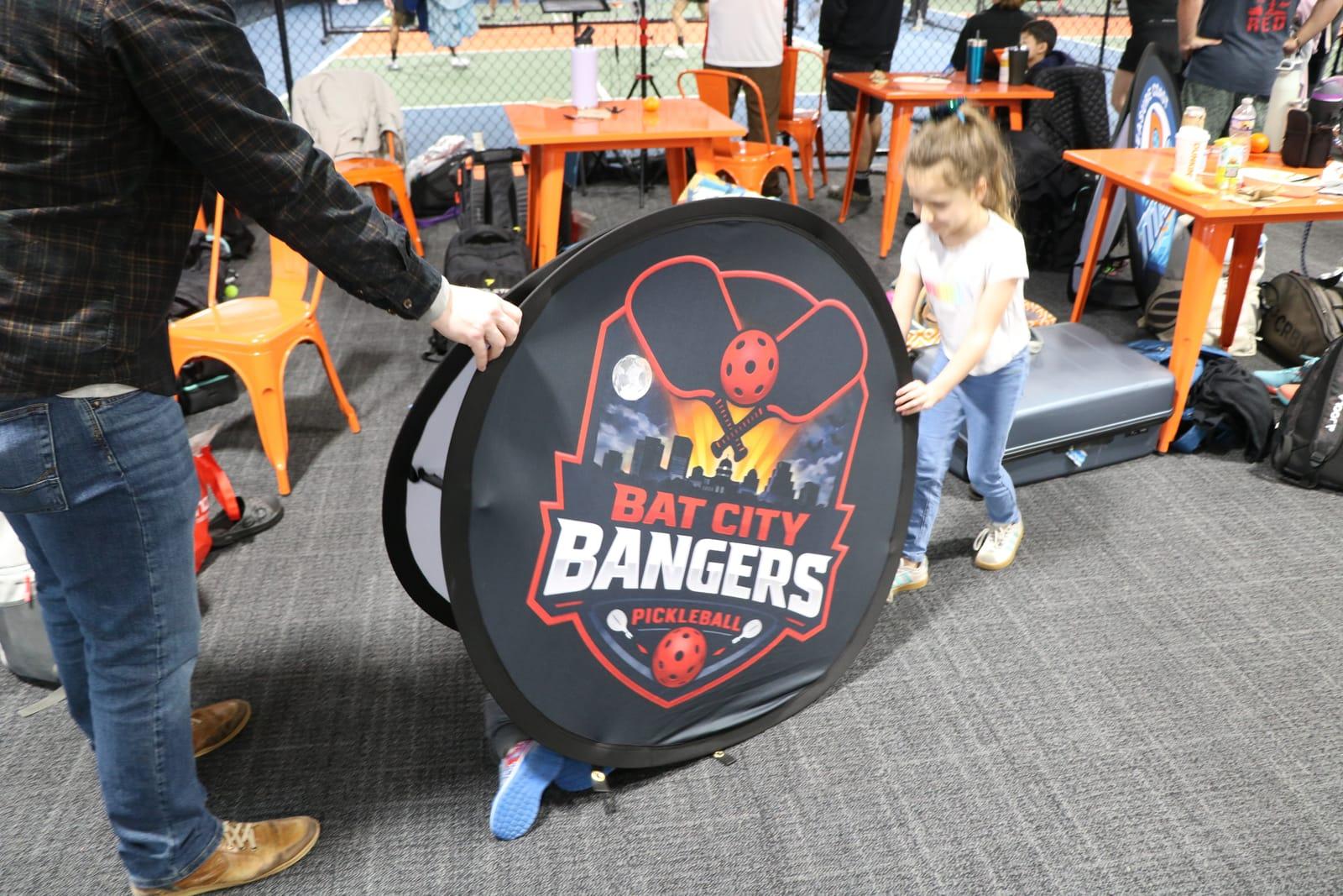 A young fan with the Bat City Bangers logo